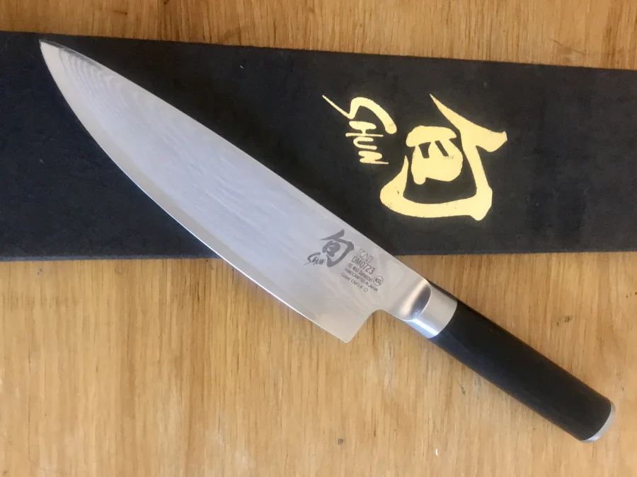 Japanese knife sharpening in Halifax Maritime Sharpening in Halifax sharpens Japanese knives such as this Shun knife lying on its box on a wooden table