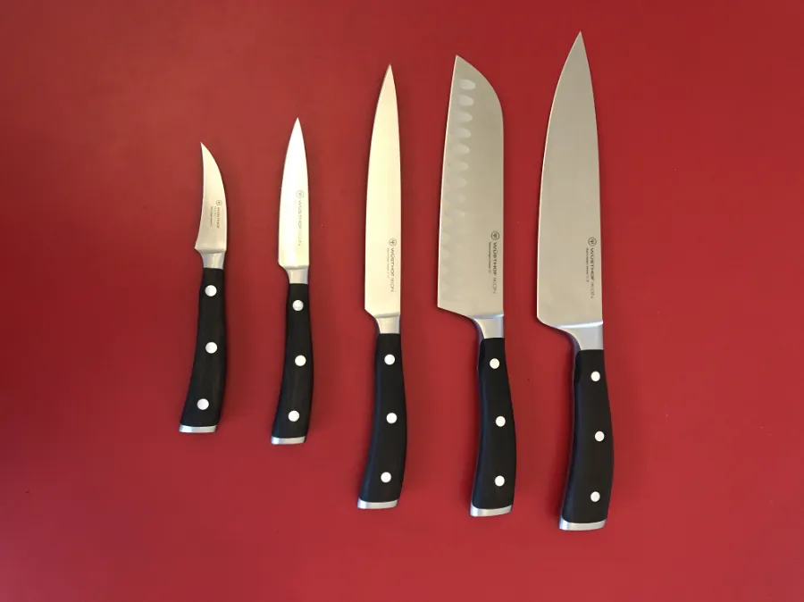 Kitchen knife sharpening Halifax set of sharpened kitchen knives on a red background